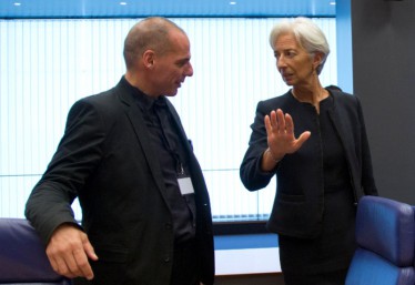 Greek Finance Minister Yanis Varoufakis  , left, speaks with Managing Director of the International Monetary Fund Christine Lagarde during a round table meeting of eurogroup finance ministers at the European Council building in Luxembourg on Thursday, June 18, 2015. German Chancellor Angela Merkel is pressing Greece to deliver on commitments to carry out reforms, stressing that she wants the country to remain in the common currency. (AP Photo/Virginia Mayo)